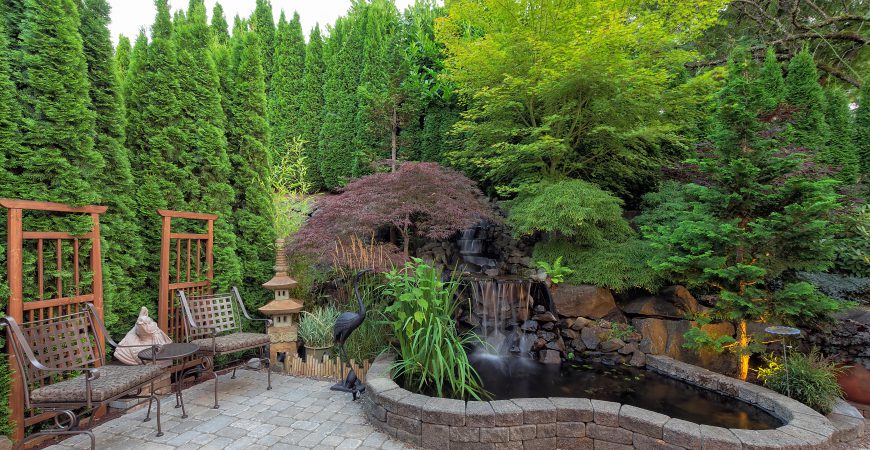 Backyard Garden landscaping with waterfall pond trees plants trellis decor patio furniture brick pavers